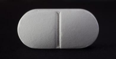 Tablet on a black background, close-up, macro photo