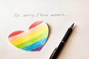 Inscription on white background I'm sorry I love women, heart in the form of a flag LGBT and a pen, lesbian photo
