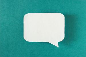 Symbol sign message from a white paper on a turquoise background, social network, message, symbol photo