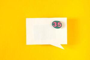 Symbol sign message from a white paper on a yellow background, social network, message photo