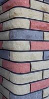 Modern multicolored brick column, background texture, close-up photo