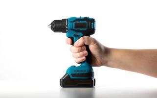 A worker holds in his hand a modern power tool, a drill-driver, on a white background, close-up, isolate photo
