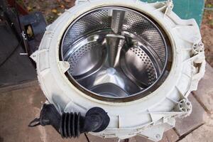 Disassembling the washing machine drum to replace the cross. Washing machine breakdown and repair, close-up photo
