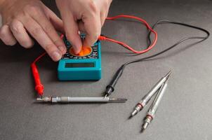 Checking the serviceability of the glow plug with a multimeter. Glow plug voltage resistance. Modern heating element, close-up photo