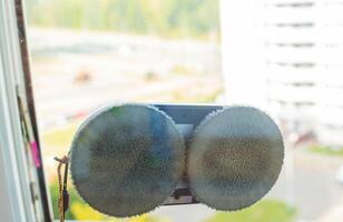 Clean windows safely with a window cleaning robot, close-up photo