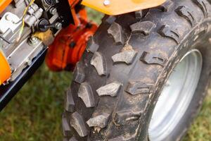 Large tread on motoblock tires. Grousers for moving on the ground. Close-up. Two-wheel tractor photo