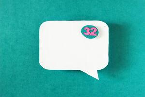 Symbol sign message from a white paper on a turquoise background, social network, message, symbol photo