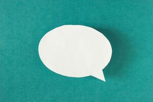 White bubble message from a paper on a turquoise background, social network, symbol photo