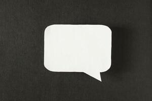 Symbol sign message from a white paper on a black background, social network, message, symbol photo