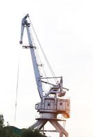 Large port crane with bucket for loading, unloading photo