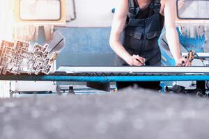 Production of PVC windows, the worker records dimensions on the profile of the frame pvc, felt pen arm photo