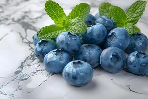Fresh Blueberries with Mint Leaves on Marble Surface for Healthy Living and Culinary Inspiration photo