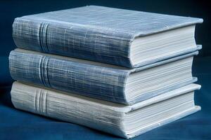 Stack of Three Blue Textured Books on Dark Background - Ideal for Education and Literature Themes photo