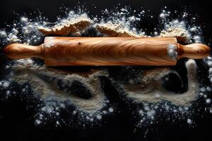 Rustic Baking Scene with Wooden Rolling Pin and Flour on Black Background photo