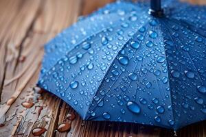 Blue Umbrella with Raindrops on Wooden Surface - Weather and Rain Concept for Stock Use photo