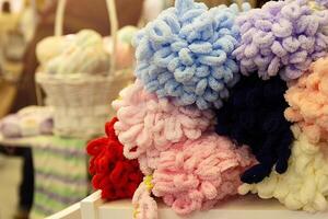 Colors wool balls on shop display stand for sale photo