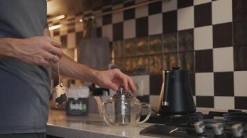 Man putting tea bag in teapot with lemon video