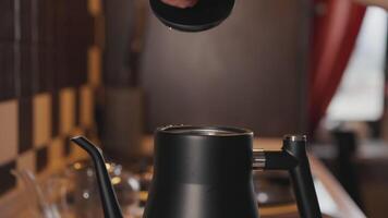 Man open the lid of a boiling kettle with steam video