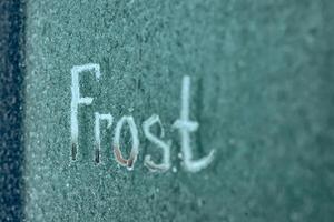 Frosted Surface With Inscription Freeze Captured in a Cold Environment photo