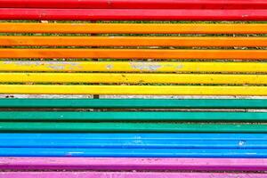 Colorful Wooden Slats Create a Vibrant Bench Design in a Sunny Park Setting photo