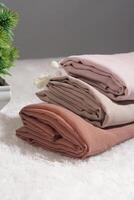 Pile of hijabs in soft colors isolated on a white background. Hijab mockup and high resolution photos. photo