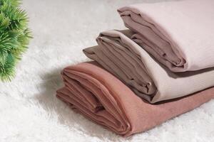Pile of hijabs in soft colors isolated on a white background. Hijab mockup and high resolution photos. photo