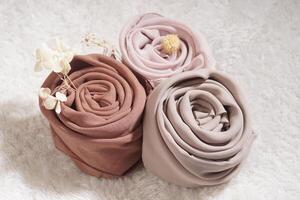 A rolled hijab in soft colors isolated on a white background. Hijab mockup and high resolution photos. photo