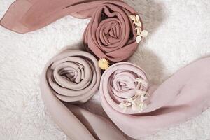 A rolled hijab in soft colors isolated on a white background. Hijab mockup and high resolution photos. photo