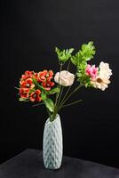 Red and white spring flowers in a vase on black background. High resolution photo. Selective focus. photo