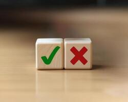 Choice Concept. Wooden Blocks with Check Mark and Cross Symbols photo