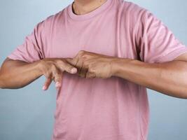 man's hand doing stretching exercises finger on white background, health care concept photo