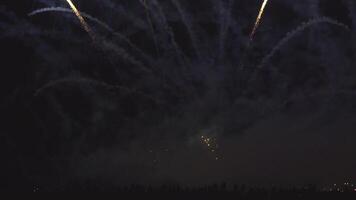 Crowd of people watch Breathtaking spectacle of international fireworks festival as vibrant colors explode against night sky. Dazzling display encompasses a wide array of shapes and patterns video