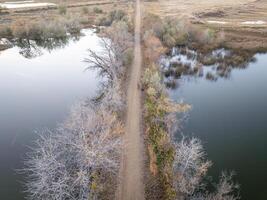 bike path at Roulard Lake near Severance, Colorado in fall scenery - Great Western Bike Trail, rails to trails conversion project photo