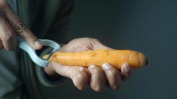 Carefully peeling a fresh and vibrant carrot using an efficient vegetable peeler tool video