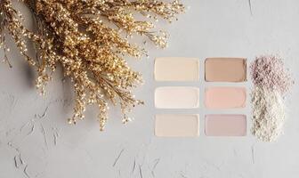 A palette showcasing four harmonious shades light beige, soft peach, medium taupe, and deep mauve, with delicate golden tinsel scattered photo