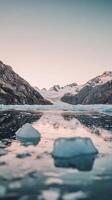 Glacier fragments floating on water surface next to mountain range , wallpaper art photo