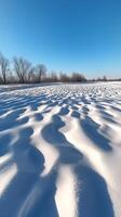 Snow drifts form waves across the open field , wallpaper art photo