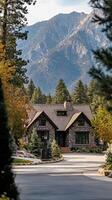 Stone cottage nestled among pine trees with distant mountains in background, wallpaper photo