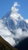 Peaks rise through cloud layers toward the sky in a mountain range, photorealistic photo
