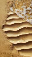 Waves break on shore creating patterns in sand, photorealistic photo