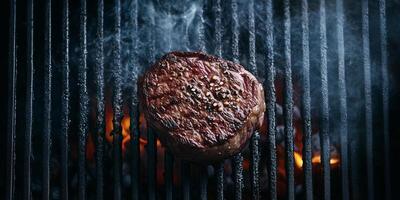 Filet mignon resting on a grill with coals glowing underneath, meal photography photo