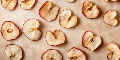 Group of dried apple slices scattered on a smooth surface, culinary photography photo