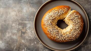 Round plate with a bagel cut in half, each side evenly spread, culinary photography photo