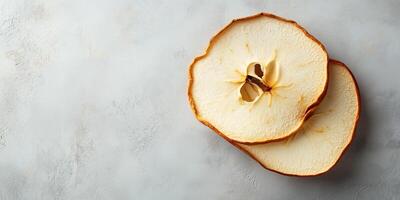 Single dried apple slice resting on another, food photography photo
