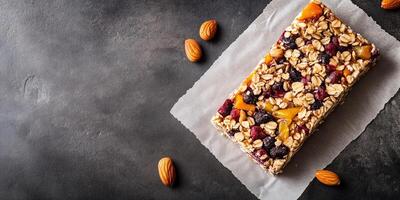 Single fruit and nut bar with visible ingredients on parchment paper, culinary photography photo