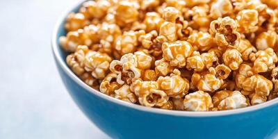 Large bowl of caramel corn, with coated popcorn kernels overflowing, photorealistic food photo