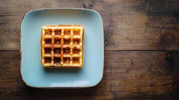 Plate with a single Belgian waffle centered on a square dish, gastronomy photography photo