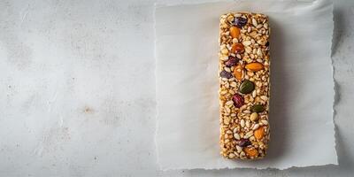 Single energy bar with grains and seeds on parchment paper, photorealistic food photo