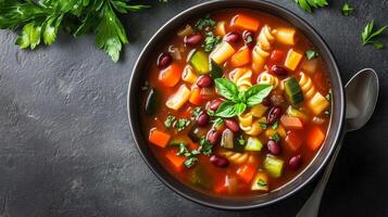Bowl of minestrone soup with vegetables, pasta, beans, and broth, meal photography photo