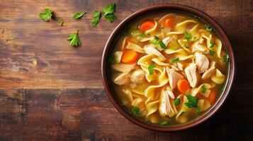 Bowl of chicken noodle soup with submerged chicken, noodles, and vegetables, meal photography photo